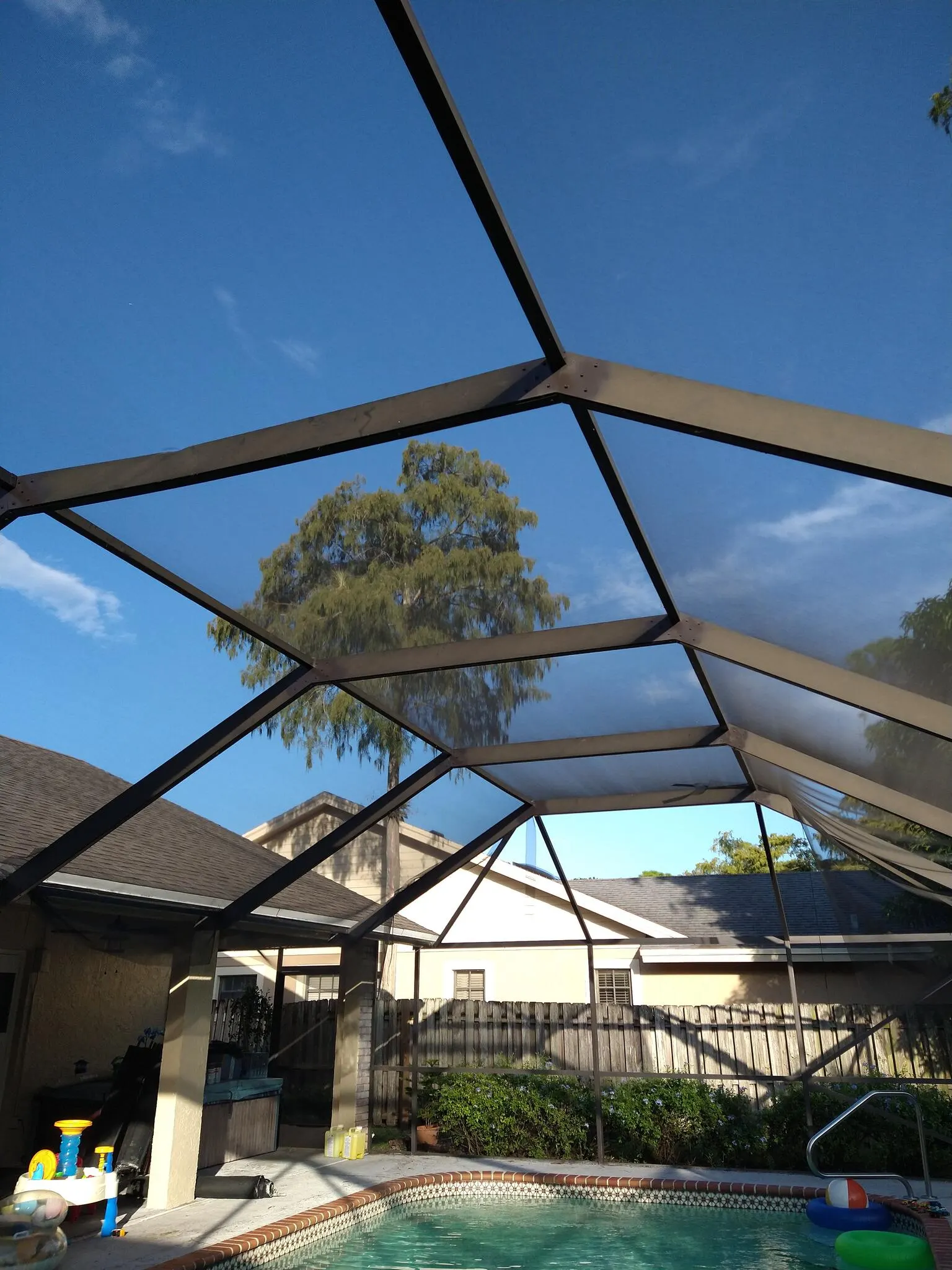 New screen on a pool cage roof, seen from inside