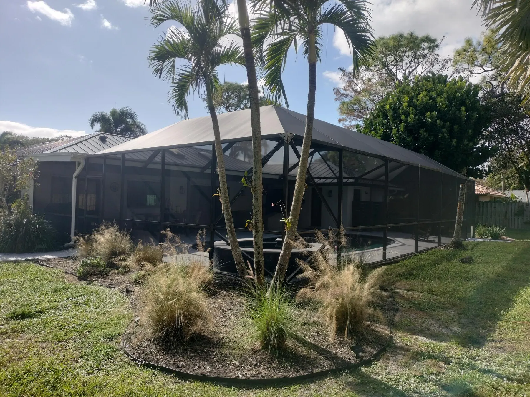 Large rescreened enclosure with a landscaped yard
